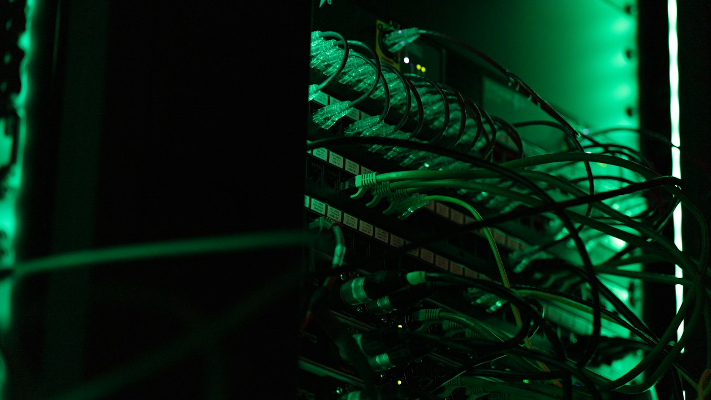 Server rack with network cabling lit in green